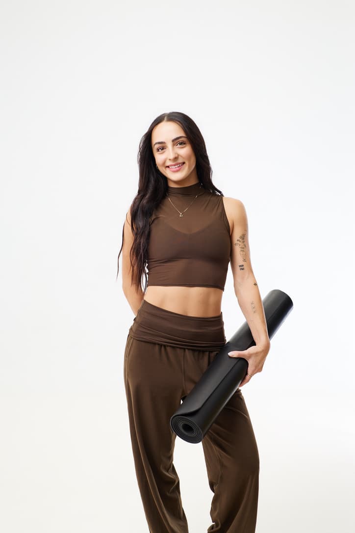 Lauren standing with her yoga mat